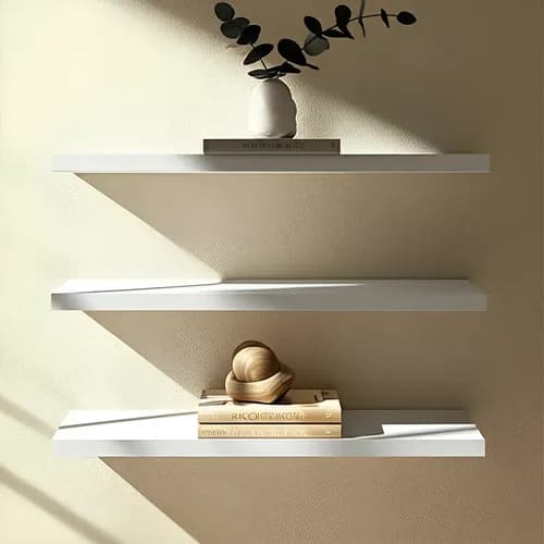 Kit de tres estantes flotantes de melamina blanca con ménsulas invisibles montados en la pared